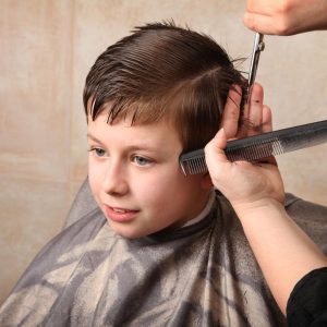 Boy having haircut at salon